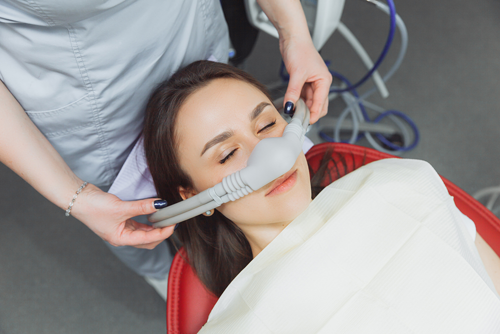 IV conscious sedation being applied to a female dental patient